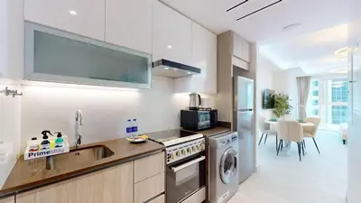 a kitchen with a sink and a dishwasher at Primestay - Elevated Studio in JLT - Dubai in Dubai