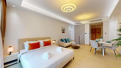 a bedroom with a bed and a living room at Primestay - Elevated Studio in JLT - Dubai in Dubai