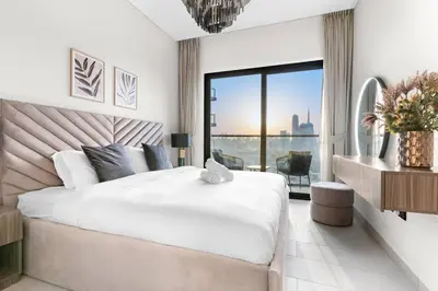 a bedroom with a large bed and a large window at FIRST CLASS Luxury 1BR plus Bunk Room in Sobha Waves, Close to Downtown Dubai in Dubai