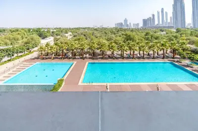 an overhead view of a swimming pool with palm trees at Silkhaus Burj Khalifa View Studio in Iconic Tower in Dubai