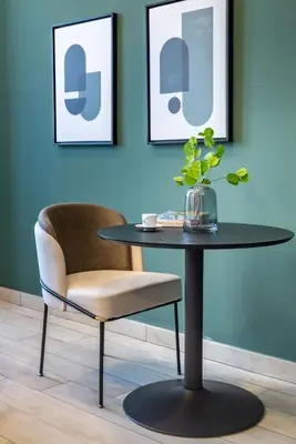 a table and a chair in a room at Silkhaus Modern Studio with Balcony in Burj Daman in Dubai