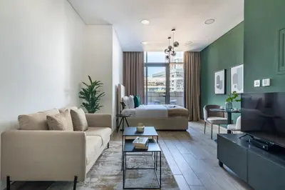 a living room with a couch and a bed at Silkhaus Modern Studio with Balcony in Burj Daman in Dubai