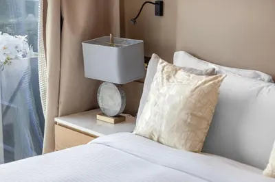 a bedroom with a bed and a lamp on a side table at Daniels 1BR Marina Horizon Retreat in Dubai