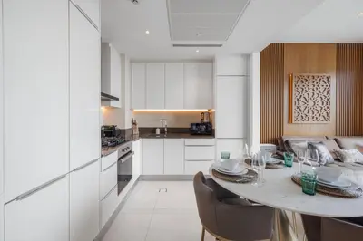 a kitchen with a table and chairs in a room at Daniels 1BR Marina Horizon Retreat in Dubai
