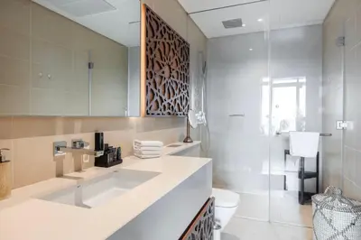 a bathroom with a sink and a toilet and a mirror at Daniels 1BR Marina Horizon Retreat in Dubai