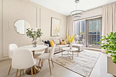 a living room with a couch and a table and chairs at Silkhaus Stylish 1 BDR with Luxurious vibes in Dubai