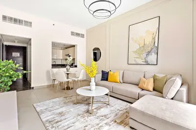a living room with a couch and a table at Silkhaus Stylish 1 BDR with Luxurious vibes in Dubai