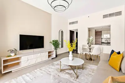 a living room with a flat screen tv on a wall at Silkhaus Stylish 1 BDR with Luxurious vibes in Dubai