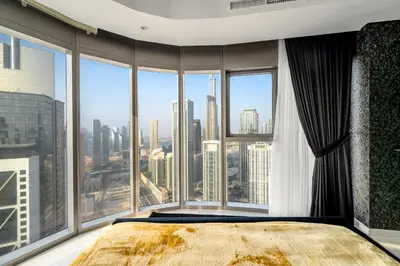 a bedroom with a large bed and large windows at Sky-High Oasis with Burj Khalifa Views, Rooftop Infinity Pool, 3BR Apartment in Paramount Hotel Midtown in Dubai