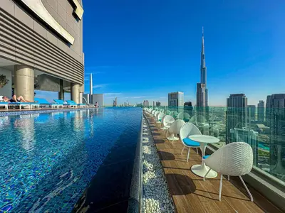 a swimming pool on top of a building at Sky-High Oasis with Burj Khalifa Views, Rooftop Infinity Pool, 3BR Apartment in Paramount Hotel Midtown in Dubai
