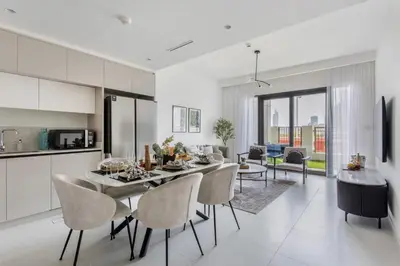 a kitchen and living room with a table and chairs at Frank Porter - Marina Vista Podium 3 in Dubai
