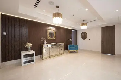a lobby with a desk and a blue chair at JuliusHomes - 5BR Villa with Pool in Palm Jumeirah in Dubai