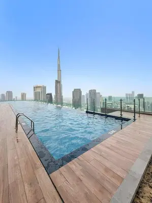 a large swimming pool with a city in the background at FIRST CLASS 2BR Luxurious High-Floor Suite in Dubai