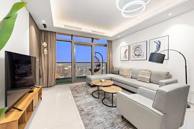 a living room with a couch and a table at FIRST CLASS 2BR Luxurious High-Floor Suite in Dubai