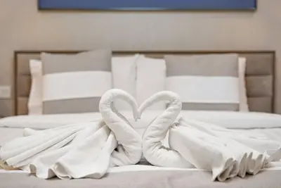 two swans making a heart on a bed at FIRST CLASS 2BR Luxurious High-Floor Suite in Dubai