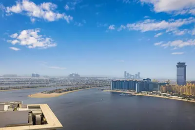 a view of a river with buildings and a city at Fully Equipped 1BR with Private Beach Access in Dubai