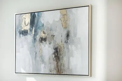 a painting with a gold frame hanging on a wall at Fully Equipped 1BR with Private Beach Access in Dubai