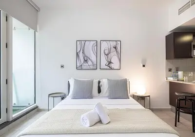 a bedroom with a large white bed with two pillows at Lux Studio in JLT with Amazing View Next to the Metro - Dubai Arch tower in Dubai