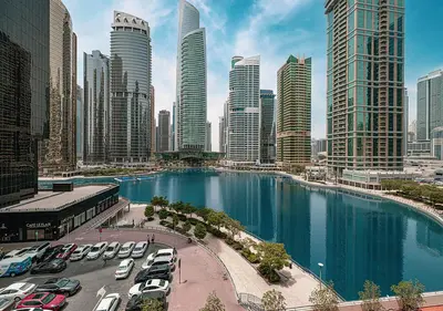a large city with cars parked in a parking lot at Lux Studio in JLT with Amazing View Next to the Metro - Dubai Arch tower in Dubai