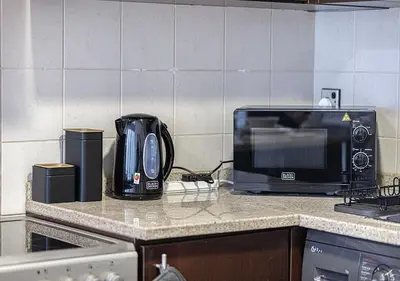 a kitchen counter with a toaster and a microwave at Lux Studio in JLT with Amazing View Next to the Metro - Dubai Arch tower in Dubai
