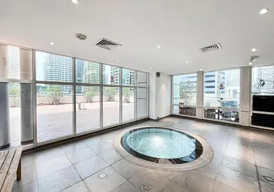 a large room with a swimming pool in a building at Lux Studio in JLT with Amazing View Next to the Metro - Dubai Arch tower in Dubai