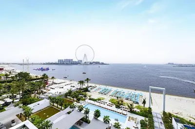an aerial view of the beach and the ferris wheel at Panoramic Sea View 2BR in JBR in Dubai