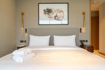 a bedroom with a large bed with towels on it at Address Residences Dubai Opera - Burj Khalifa City Views 1, 2, & 3-Bedroom Apartment 1 minute walk to Burj Khalifa, Dubai Mall, Dubai Fountain by Heaven Crest in Dubai