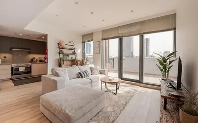a living room with a couch and a table at Modern JVC 1BR with Spacious Terrace in Dubai