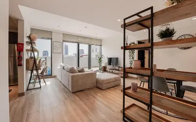 a living room with a loft bed and a couch at Modern JVC 1BR with Spacious Terrace in Dubai