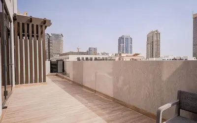 a balcony of a building with a view of the city at Modern JVC 1BR with Spacious Terrace in Dubai