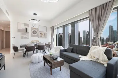 a living room with a couch and a table at 5 Minute Walk to The Fountains! Full Burj Khalifa View! 5-star Pool & Gym! in Dubai