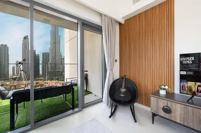 a room with a balcony with a view of the city at 5 Minute Walk to The Fountains! Full Burj Khalifa View! 5-star Pool & Gym! in Dubai