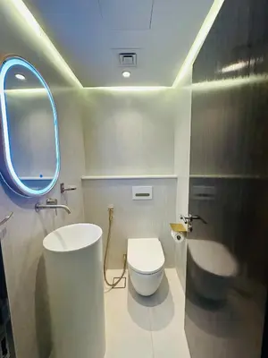 a bathroom with a toilet and a sink and a mirror at ModernLux - Brand New Modern 1BR Apartment with Lake View, JLT close to Metro in Dubai