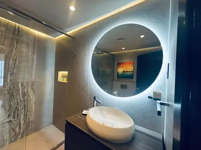 a bathroom with a white sink and a mirror at ModernLux - Brand New Modern 1BR Apartment with Lake View, JLT close to Metro in Dubai