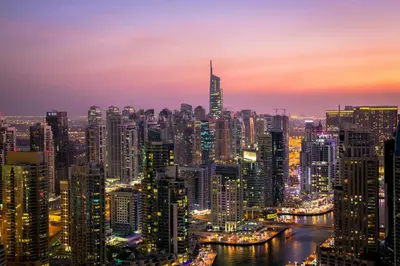 a night view of a large city at night at ModernLux - Brand New Modern 1BR Apartment with Lake View, JLT close to Metro in Dubai