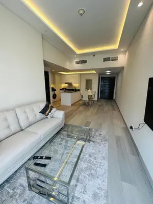 a living room with a white couch and a glass table at ModernLux - Brand New Modern 1BR Apartment with Lake View, JLT close to Metro in Dubai