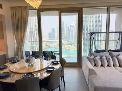 a living room with a table and a couch at Incredible View - Fountain show - 4BR - PS5 and Games in Dubai