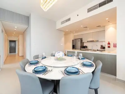 a dining room with a white table and chairs at Incredible View - Fountain show - 4BR - PS5 and Games in Dubai