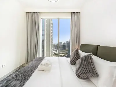 a bedroom with a large white bed with a large window at Incredible View - Fountain show - 4BR - PS5 and Games in Dubai