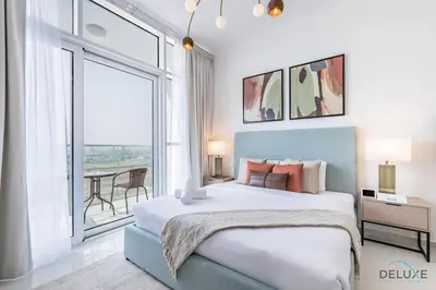 a bedroom with a large bed and a large window at Inviting Studio in Damac Hills Carson B, Dubailand by Deluxe Holiday Homes in Dubai