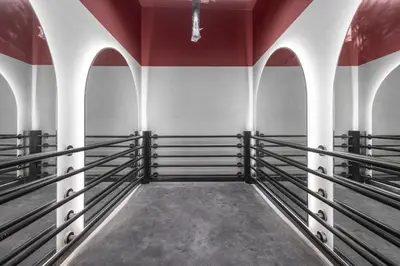 an empty room with black boxing stalls in a building at Premium Studio Apartment at Loci Residences JVC in Dubai