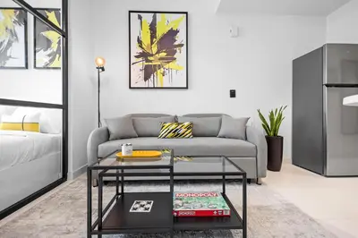 a living room with a couch and a coffee table at Premium Studio Apartment at Loci Residences JVC in Dubai