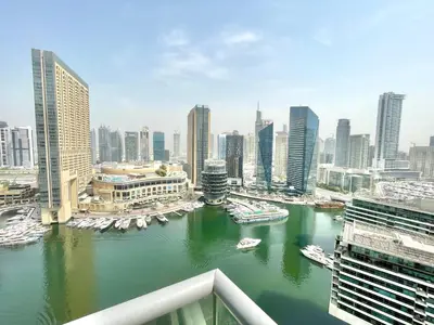 a view of a river with boats in a city at Vacay Lettings - Bay Central Tower - Studio in Dubai