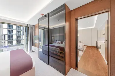 a bedroom with a bed and a large glass door at Vonder Bluewaters Residences SA2 in Dubai