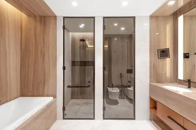 a bathroom with a shower and a tub and a toilet at Vonder Bluewaters Residences SA2 in Dubai
