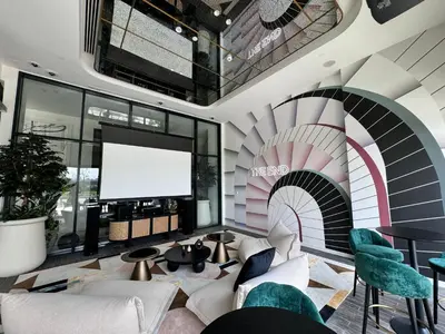 a living room with a large screen in a building at Chic 1 BR apartment at Golfville in Dubai