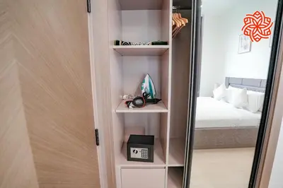 a room with a mirror next to a bed at Alashrafia Saray - Bright 1bdr apartment in JVC in Dubai