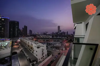 a view of a city at night from a building at Alashrafia Saray - Bright 1bdr apartment in JVC in Dubai