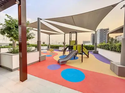 a playground with a slide and a swing at Azizi Riviera 47 - Comfortable Studio in Meydan in Dubai