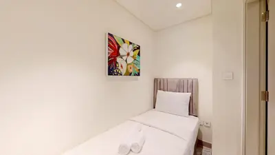 a small room with a bed and a picture on the wall at Locations I Spacious Modern 3 Bedroom I Luxury Stay Near Dubai Mall & Burj Khalifa I Pool, Gym, Parking & Wi-Fi in Dubai